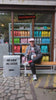 A guest sitting outside the Caffenation bar with a coffee in hand