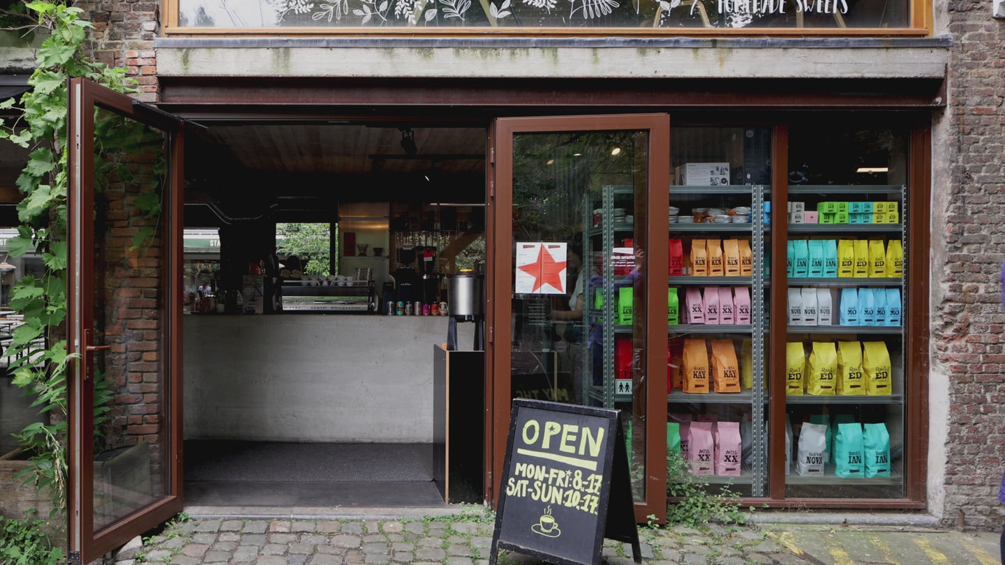 The Caffenation bar on the Vlaamsekaai in Antwerp, with coffee bags stacked in the window